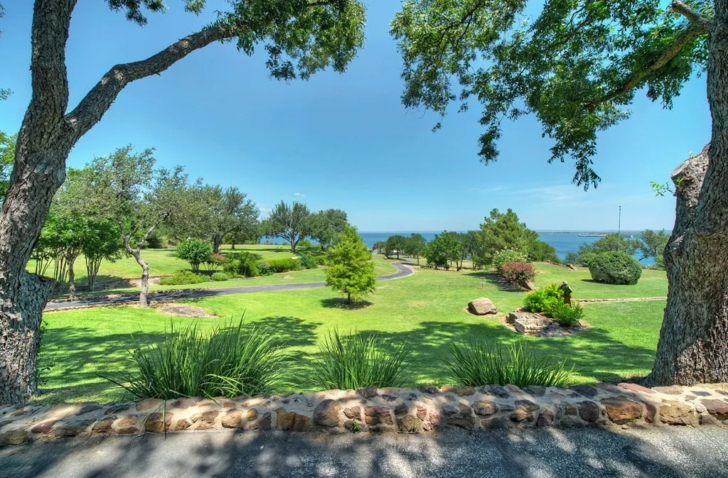 View through oak branches across the lawn toward the lake