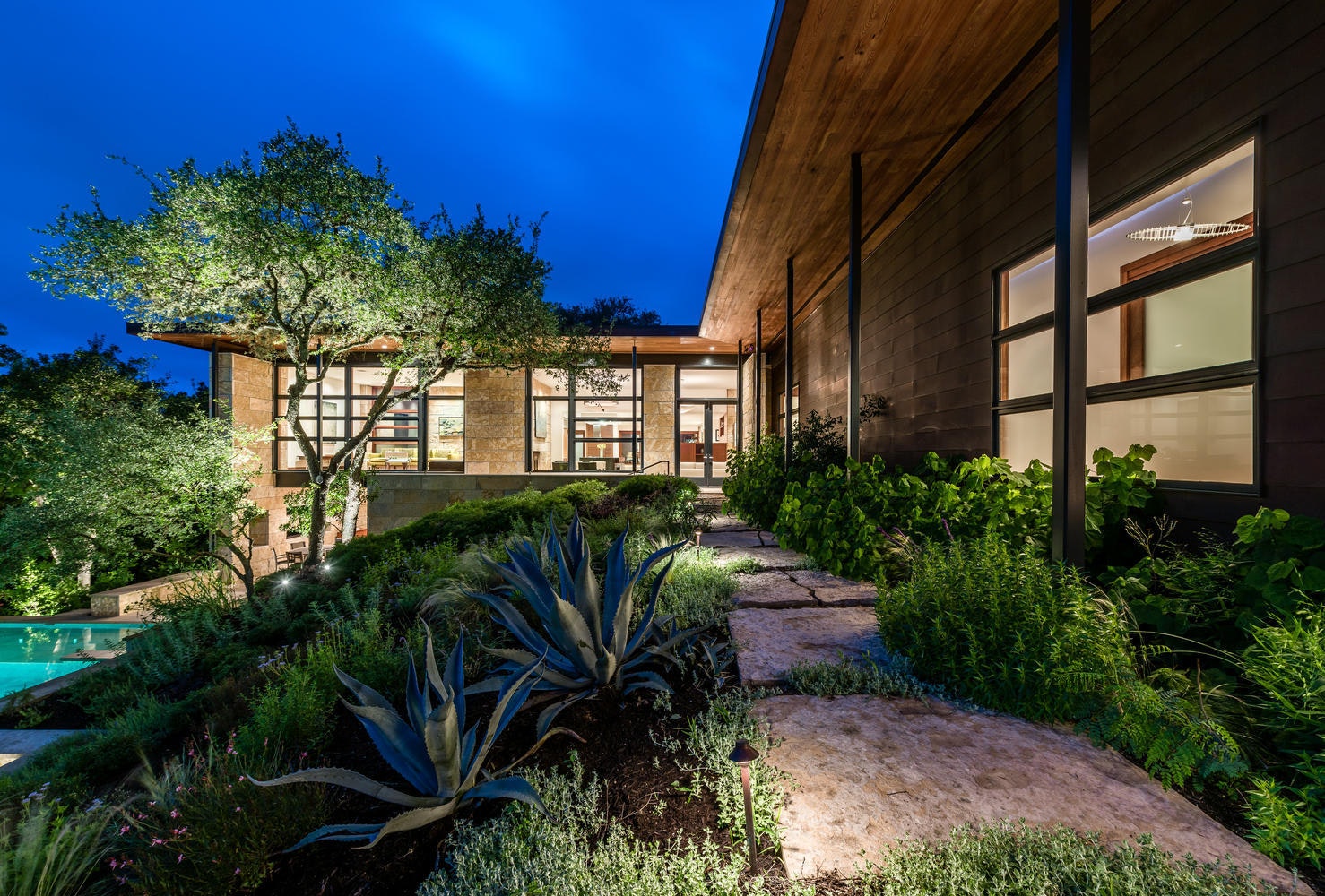 The main house and stone garden pathway at dusk